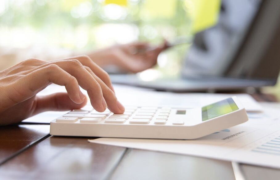 Someone typing on a calculator