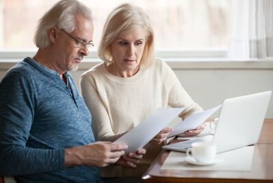 Two people looking at contracts