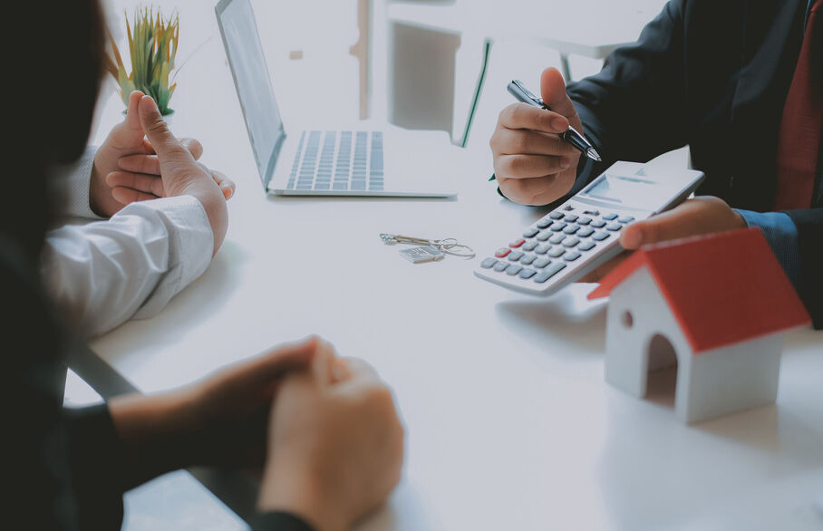 Couple discussing finances with a broker