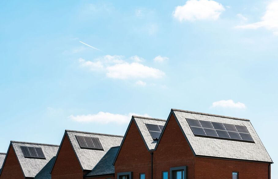 A row of houses with solar panels on the rooves