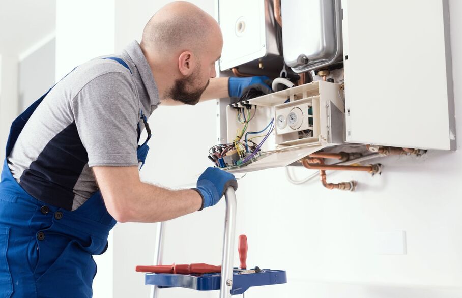 gas engineer fixing boiler