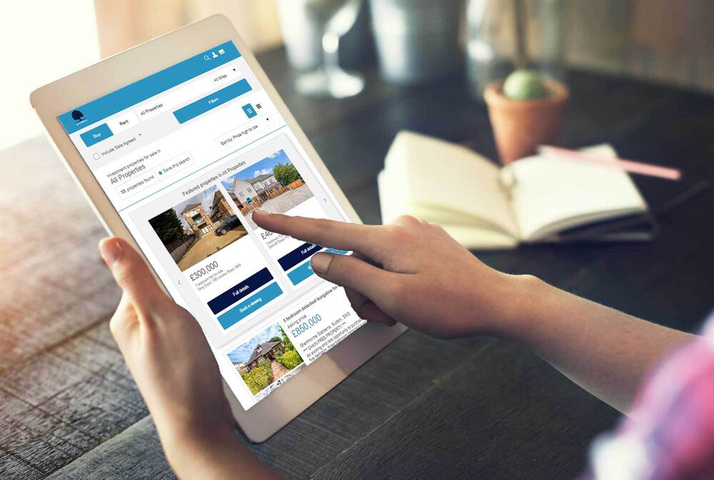 looking at investment properties on tablet