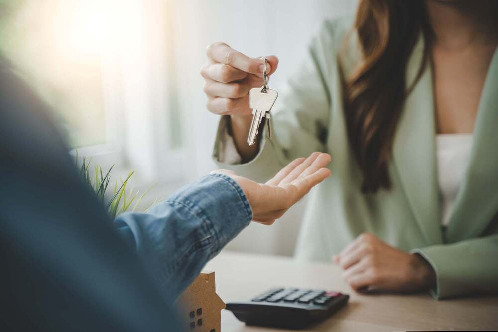 Two people exchanging a set of keys