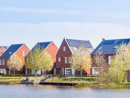 A row of houses by a lake