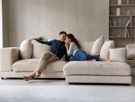 A couple sitting on a sofa