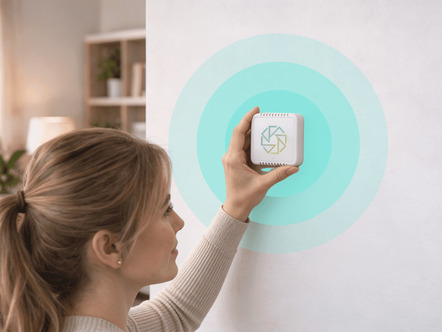 Woman fitting mould protection device on wall