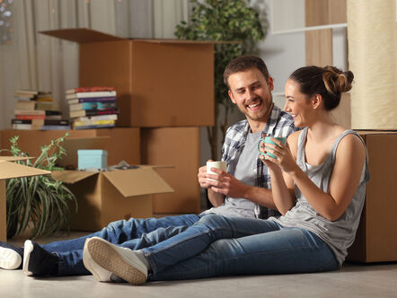 Couple relaxing on floor after moving in