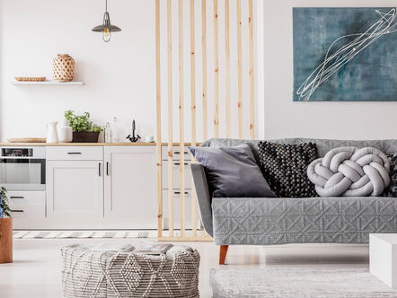 Grey sofa in empty open plan apartment