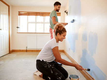 Couple painting a wall