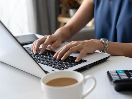 Person at a desk with a laptop